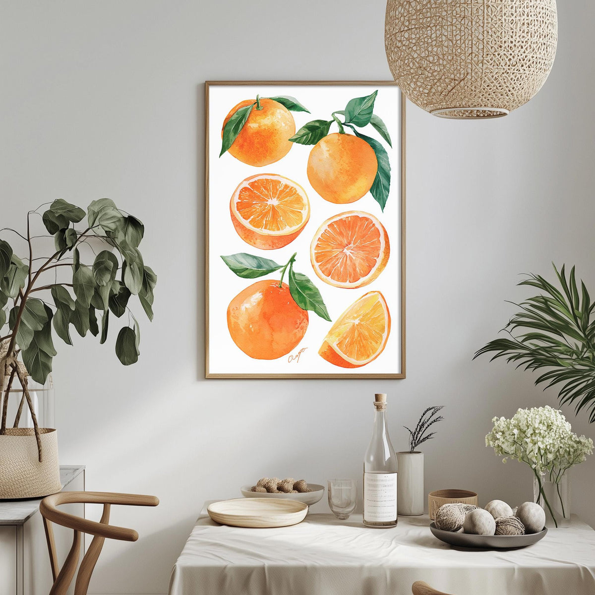 a framed print of oranges hanging on a wall, with a dining table and chairs in the foreground.