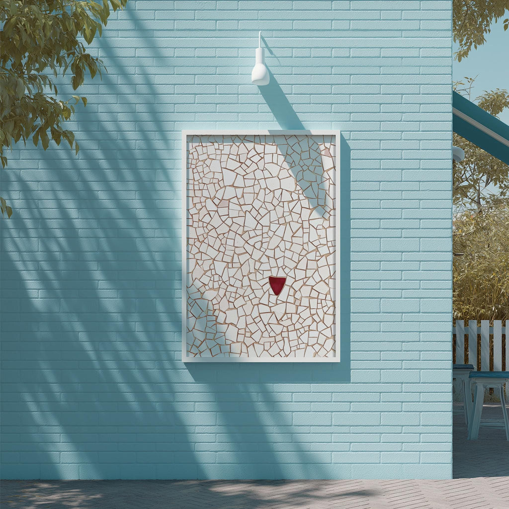 a blue brick wall with a white square frame containing a mosaic design. The mosaic appears to be made of small tiles or stones, creating a visually striking pattern. The wall is situated next to a tree, and there is a white light fixture mounted on the wall above the frame.