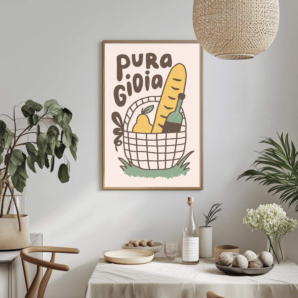 a dining table with a bowl of fruit, a bottle, and a vase, along with a potted plant and a hanging light fixture. Above the table, there is a framed poster with the text "PURA GIOLA" and an illustration of a basket with various fruits and vegetables.