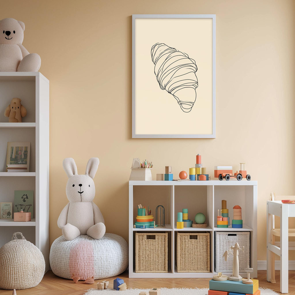 A cozy children's room with a white bookshelf, a plush rabbit, and a toy train set. The walls are painted a light peach color, and there is a framed illustration of a croissant on the wall.