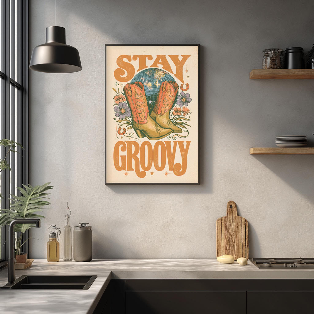 a framed poster with the text "STAY GROOovy" hanging on a wall above a kitchen counter with various kitchen items such as a cutting board, a bottle, and a bowl.