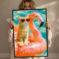 A woman holds up a framed painting depicting a cat wearing sunglasses and sitting on a pink flamingo float.