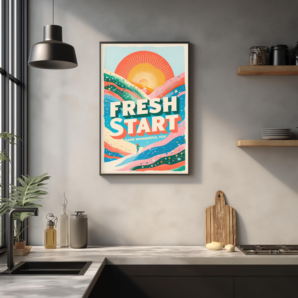 a kitchen counter with various kitchen items, such as a cutting board, a soap dispenser, and a plant. Above the counter, there is a framed poster with a colorful design and the text "FRESH START" written on it.