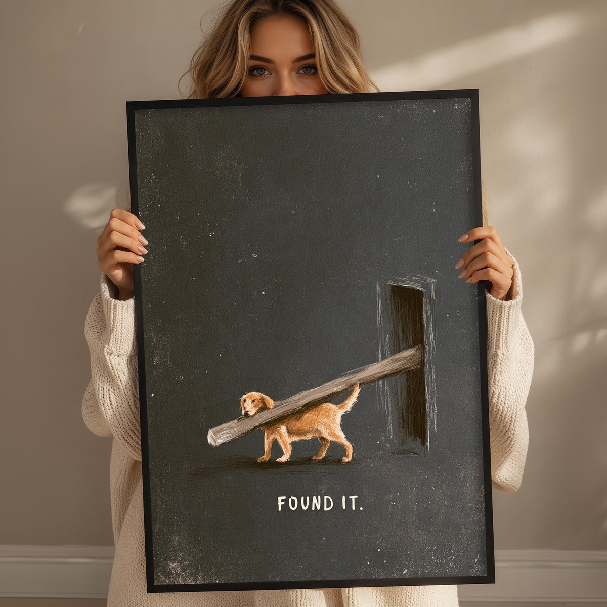 A woman holding a framed artwork depicting a dog carrying a large wooden log.