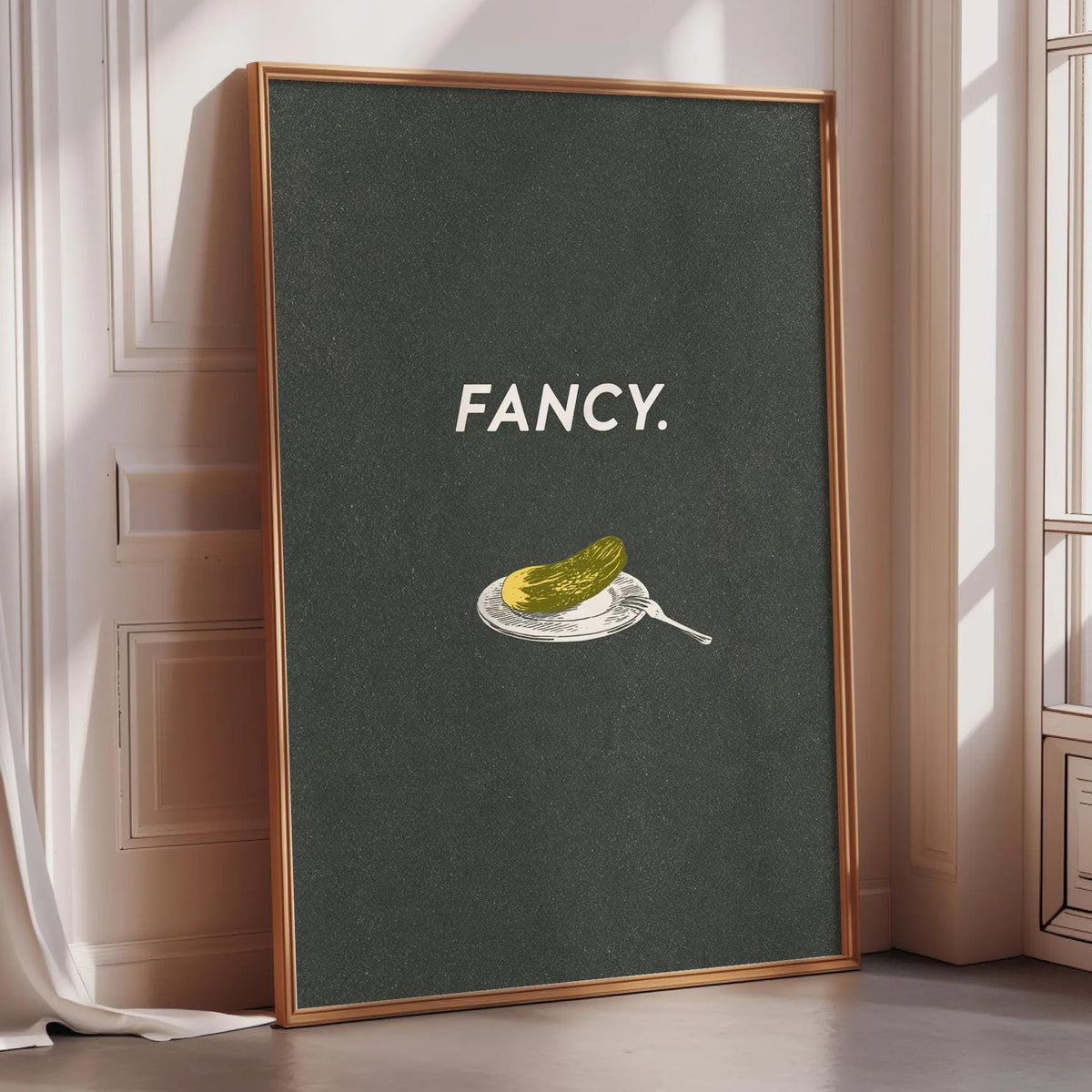 a framed poster with the word "FANCY" written on it, along with an illustration of a pickle on a plate.