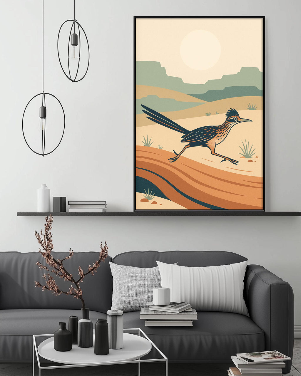 a modern living room with a gray sofa, a coffee table, and a large framed artwork depicting a roadrunner running across a desert landscape.