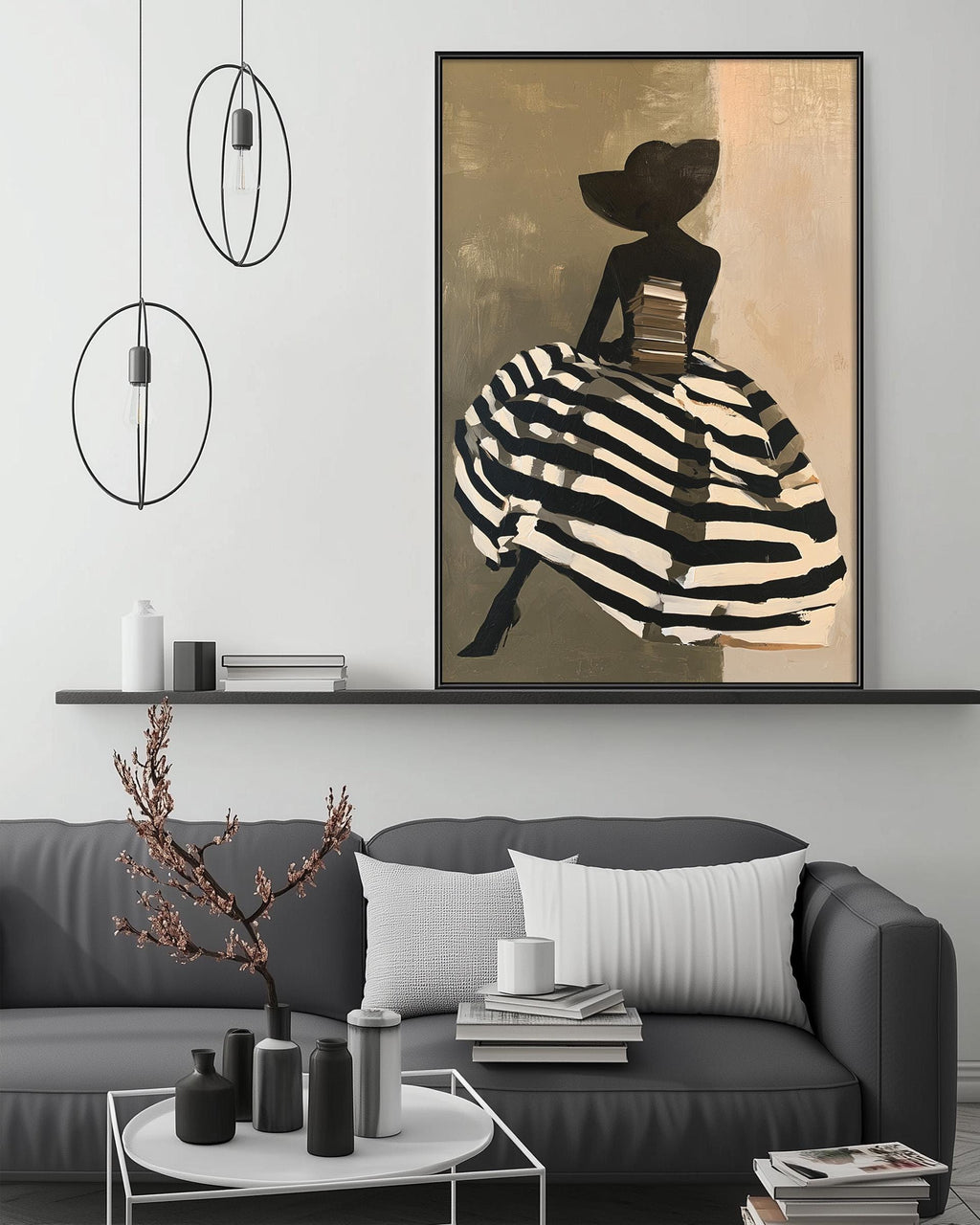 a modern living room with a gray sofa, a coffee table, and a large framed painting of a woman in a black and white striped dress. The painting is hanging above the sofa, creating a focal point in the room.