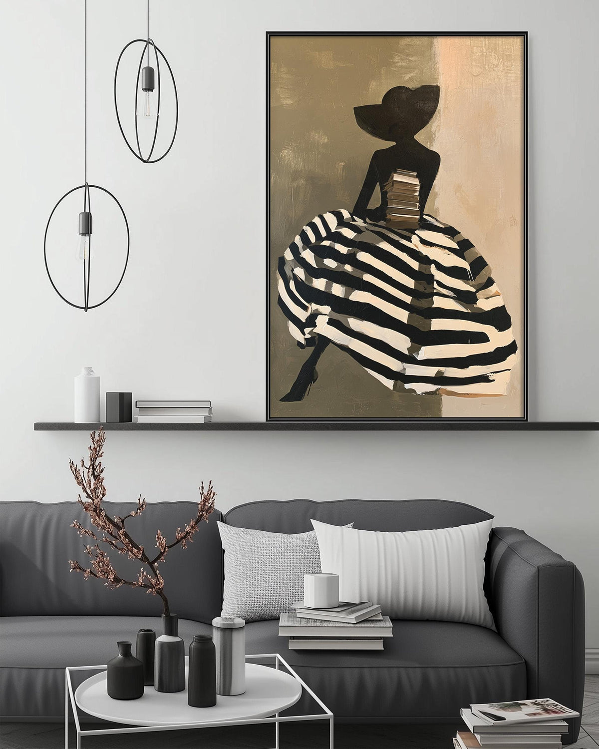 a modern living room with a gray sofa, a coffee table, and a large framed painting of a woman in a black and white striped dress. The painting is hanging above the sofa, creating a focal point in the room.