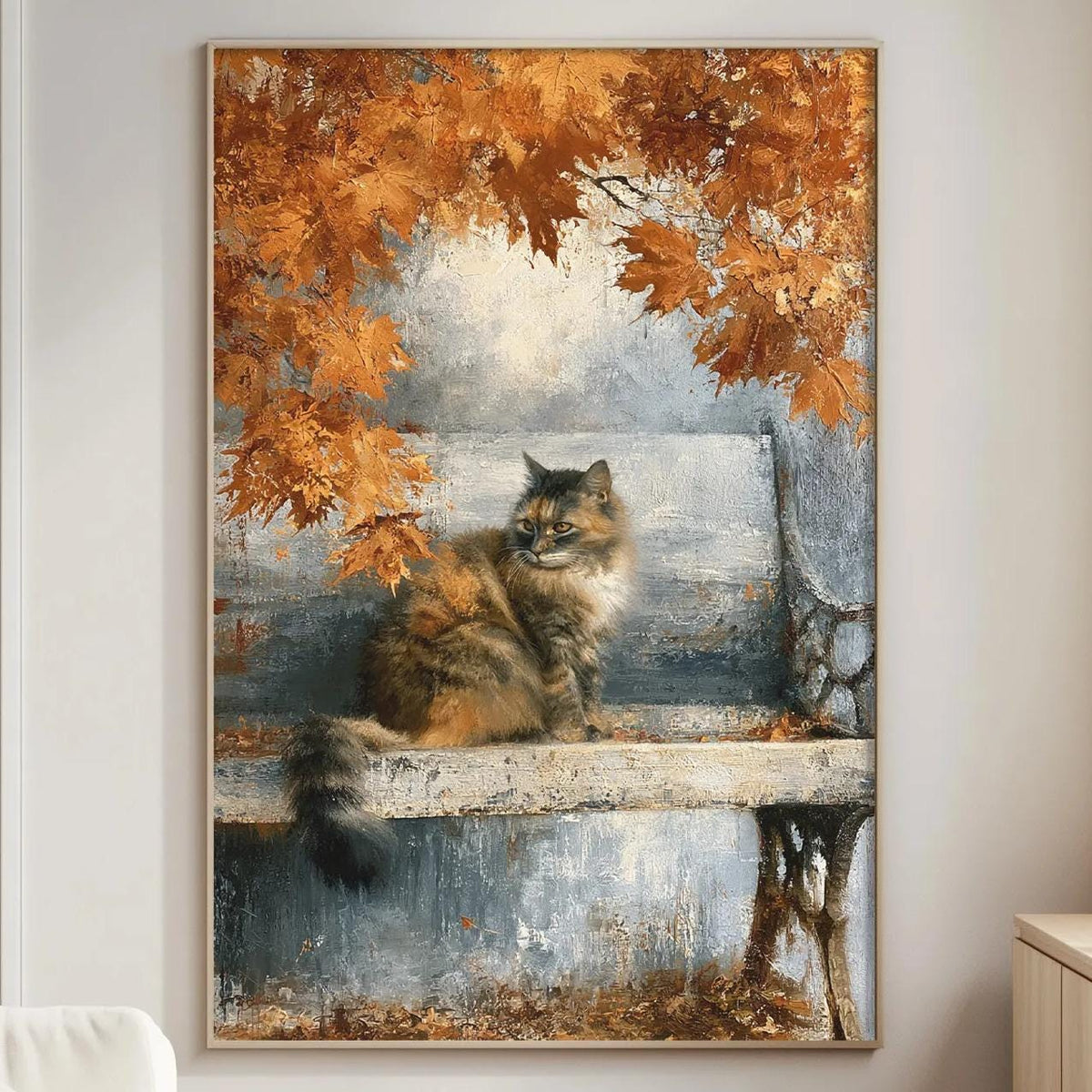 a large painting of a cat sitting on a bench, surrounded by autumn leaves, hanging on a wall in a living room.