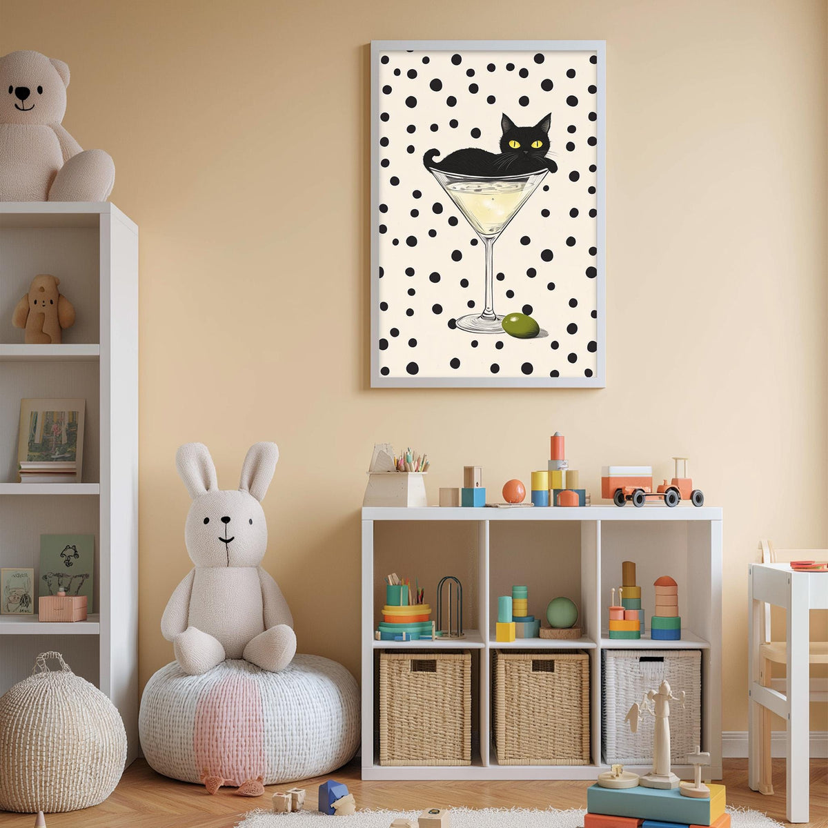 A child's bedroom with a white bookshelf, a stuffed rabbit, and a toy train. Above the bookshelf is a framed picture of a cat in a martini glass.