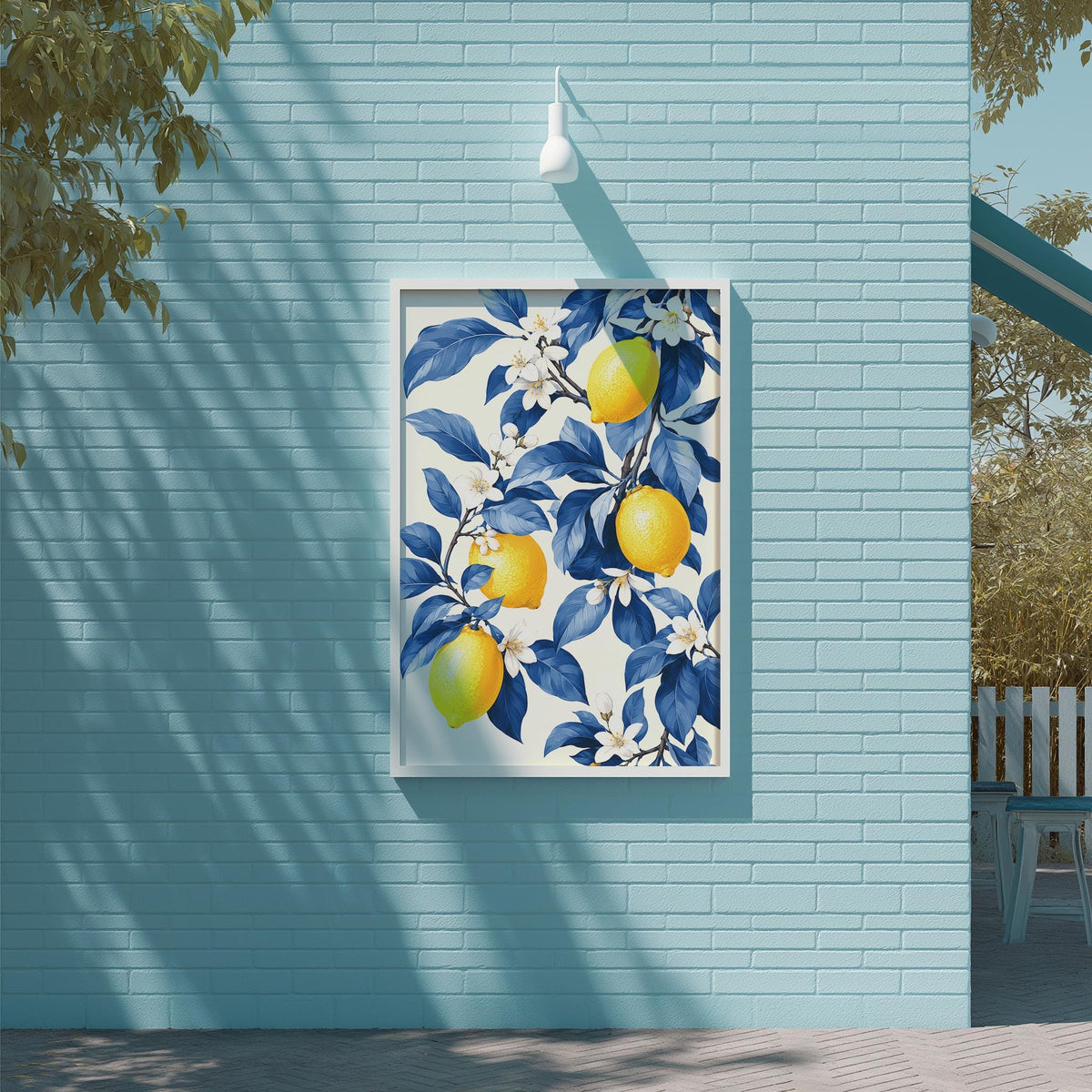 a blue brick wall with a framed painting of lemons and blue flowers hanging on it.
