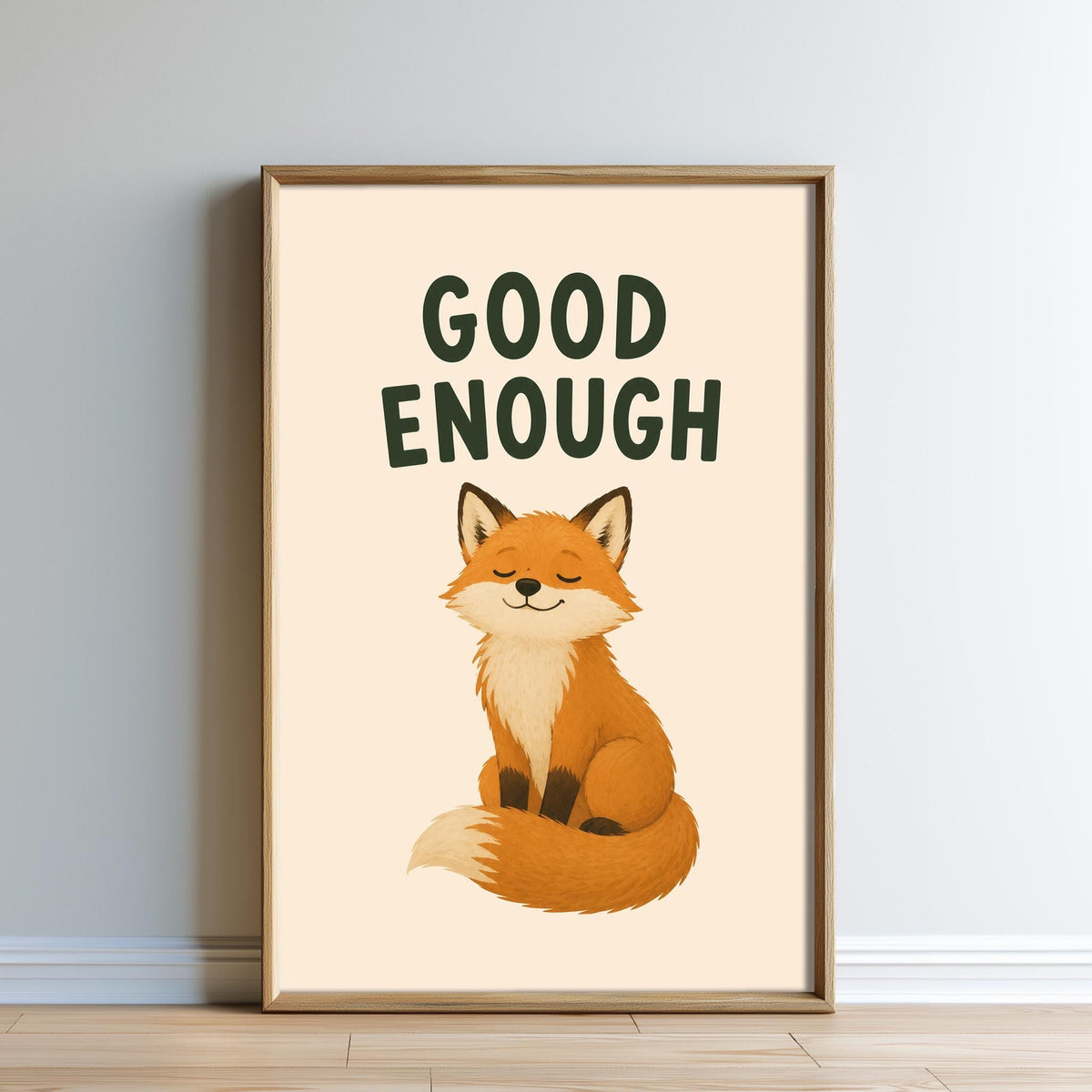 a framed poster with a cartoon illustration of a fox sitting and smiling. The text above the illustration says "GOOD ENOUGH".