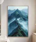 a large framed picture of a mountainous landscape with a misty, hazy effect, hanging on a wall in a living room setting.
