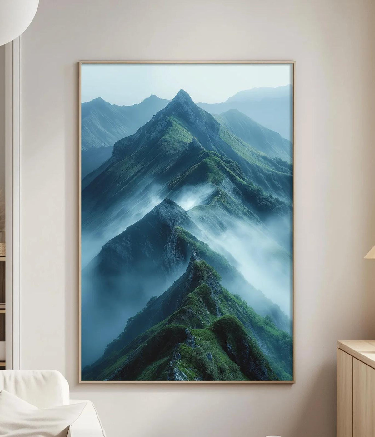 a large framed picture of a mountainous landscape with a misty, hazy effect, hanging on a wall in a living room setting.