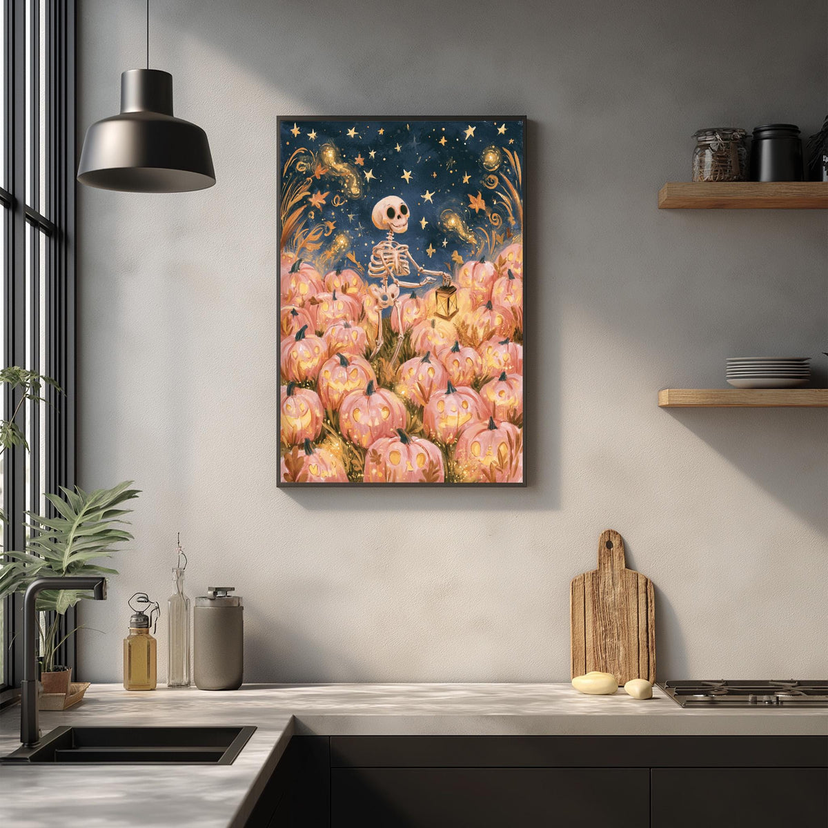a kitchen counter with a framed artwork of a skeleton holding a lantern, surrounded by pumpkins and a starry night sky.