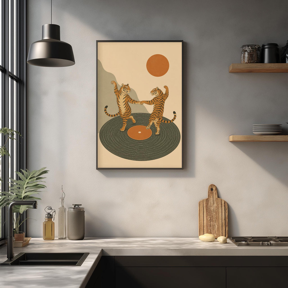 a framed illustration of two tigers dancing on a record player, set against a beige background with a large orange circle in the center. The kitchen counter is decorated with various items, including a plant, a cutting board, and a bottle.