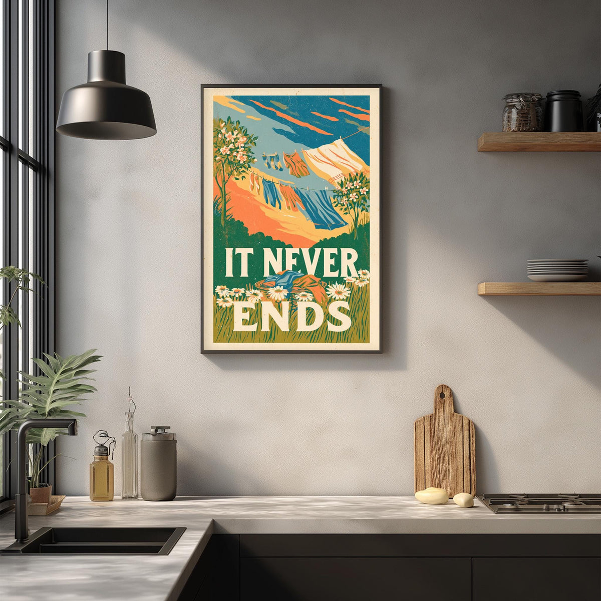 a framed poster with a colorful mountain landscape and the text "IT NEVER ENDS" hanging on a wall above a kitchen counter.