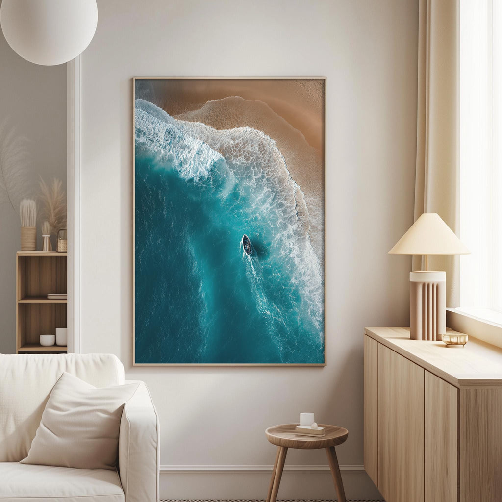 a large framed picture of a seascape with a boat in the water, hanging on a wall in a living room.