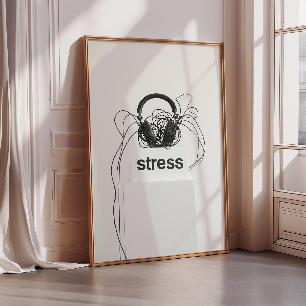a framed poster with the word "stress" written on it, along with a pair of headphones and tangled wires.