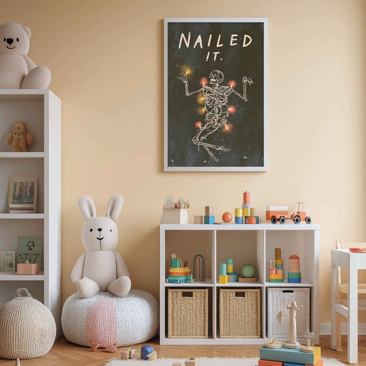 A child's bedroom with a white bookshelf, a stuffed rabbit, and a toy train. Above the bookshelf is a framed poster with a skeleton and the text "Nailed it."