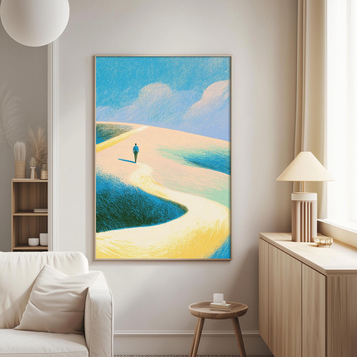 a large, colorful painting of a person walking on a beach, with a blue sky and clouds in the background. The painting is hung on a wall in a living room setting, with a white couch and a wooden side table nearby.