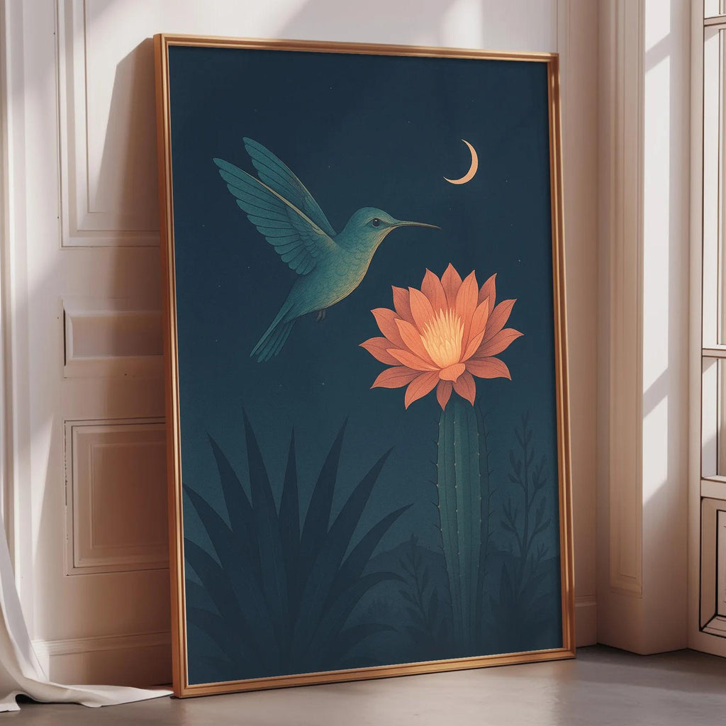 a framed painting of a hummingbird hovering over a cactus with a large flower blooming on it, set against a dark blue background with a crescent moon and stars.