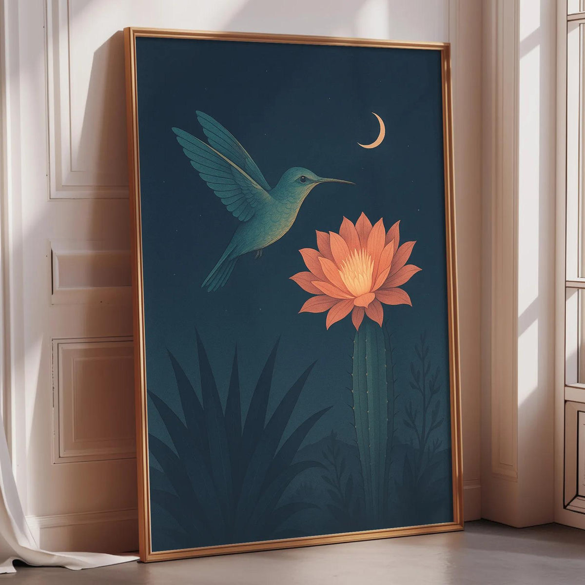 a framed painting of a hummingbird hovering over a cactus with a large flower blooming on it, set against a dark blue background with a crescent moon and stars.