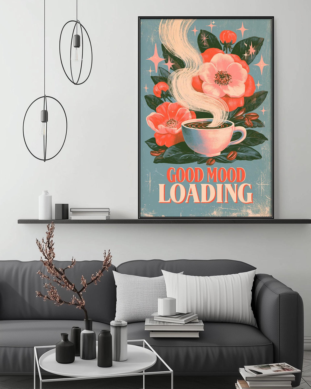 a cozy living room with a gray couch, a coffee table, and a framed poster on the wall. The poster has a floral design with a cup of coffee and the text "Good mood loading" written on it.