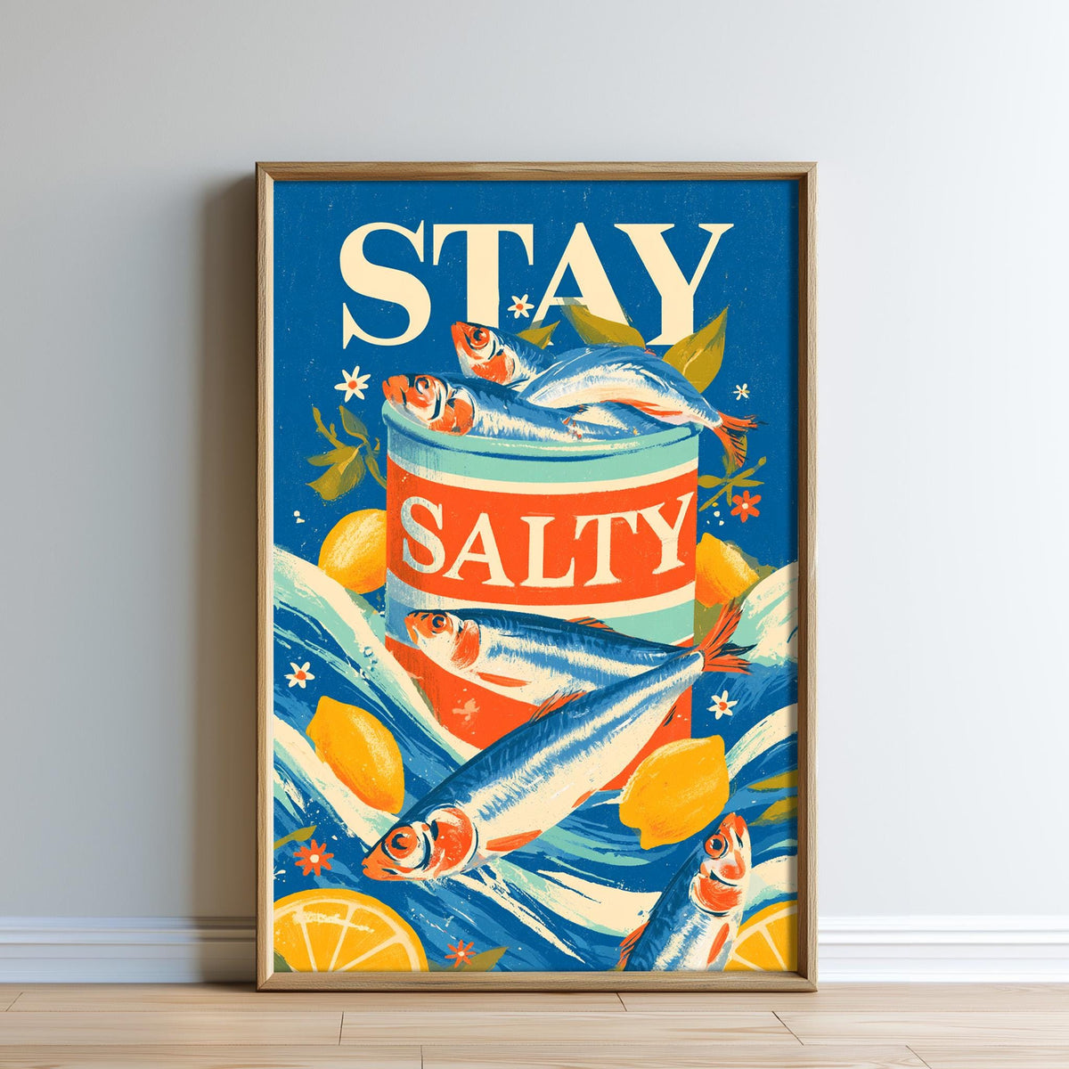 The image is a framed poster with a vibrant design featuring fish, lemons, and the text "STAY SALTY".