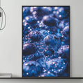 a modern living room with a gray sofa, a coffee table, and a large framed print of blueberries hanging on the wall above the sofa.