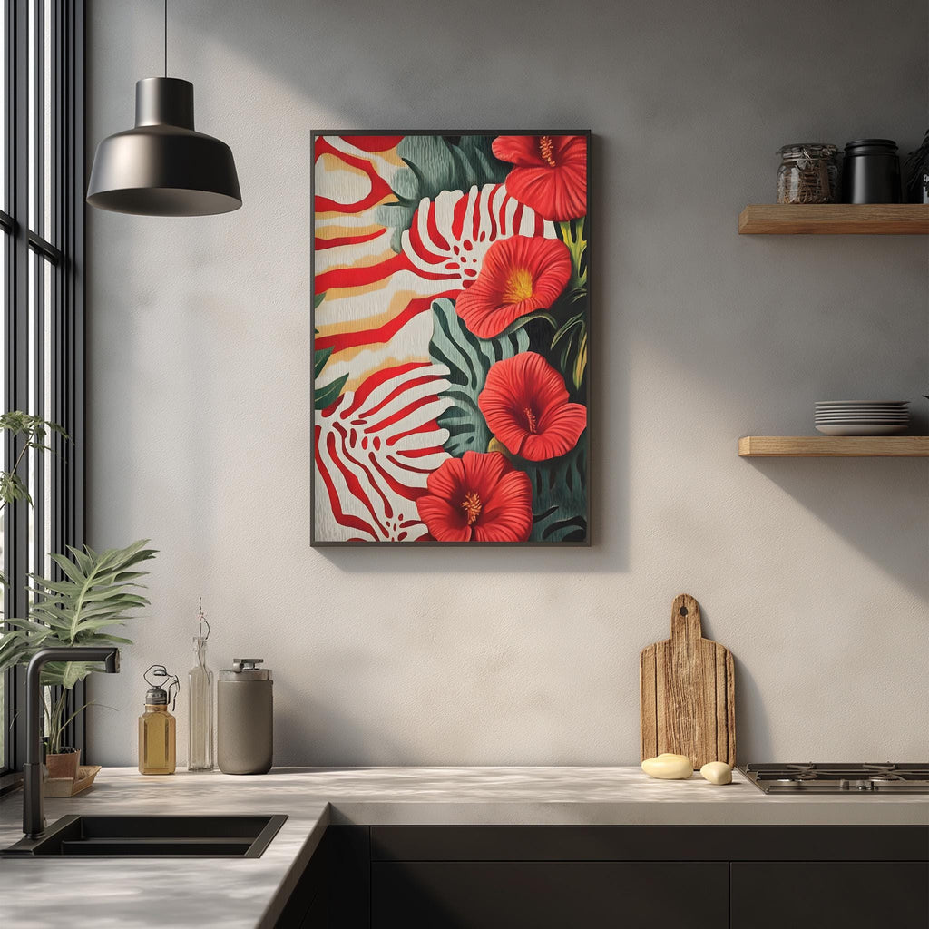 a kitchen counter with a framed print of red and green tropical flowers hanging above it. The counter also has various kitchen items such as a cutting board, a soap dispenser, and a bottle.