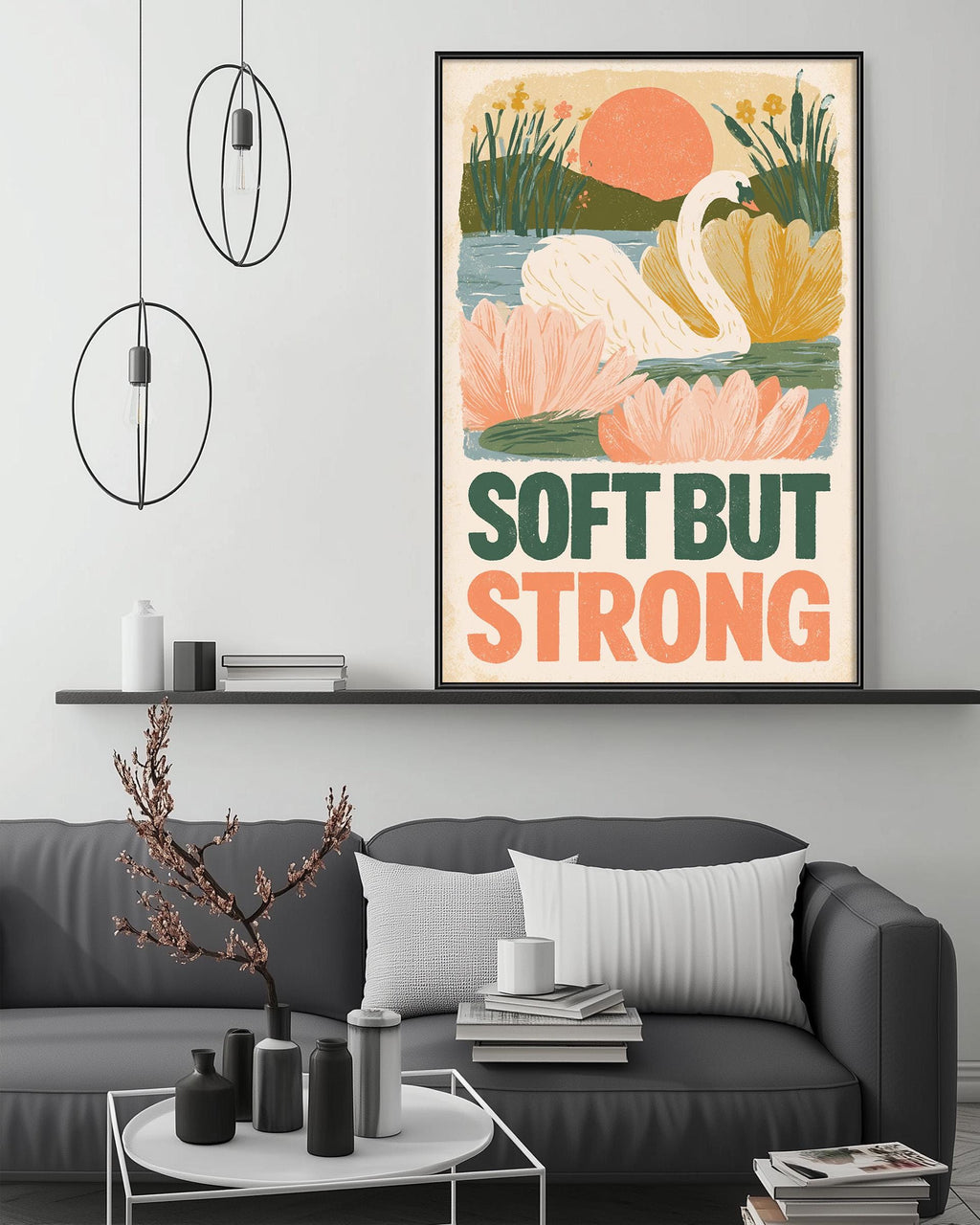 a living room with a gray couch, a coffee table, and a framed poster with a swan and flowers on the wall.