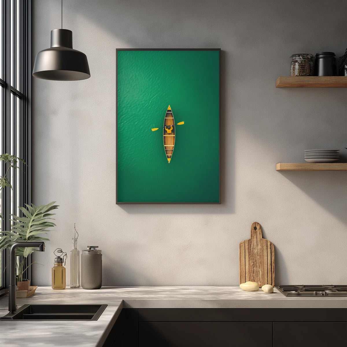a kitchen counter with various kitchen items, including a cutting board, a bottle, and a vase. Above the counter, there is a framed image of a canoe on a green background, and a hanging light fixture is visible in the background.