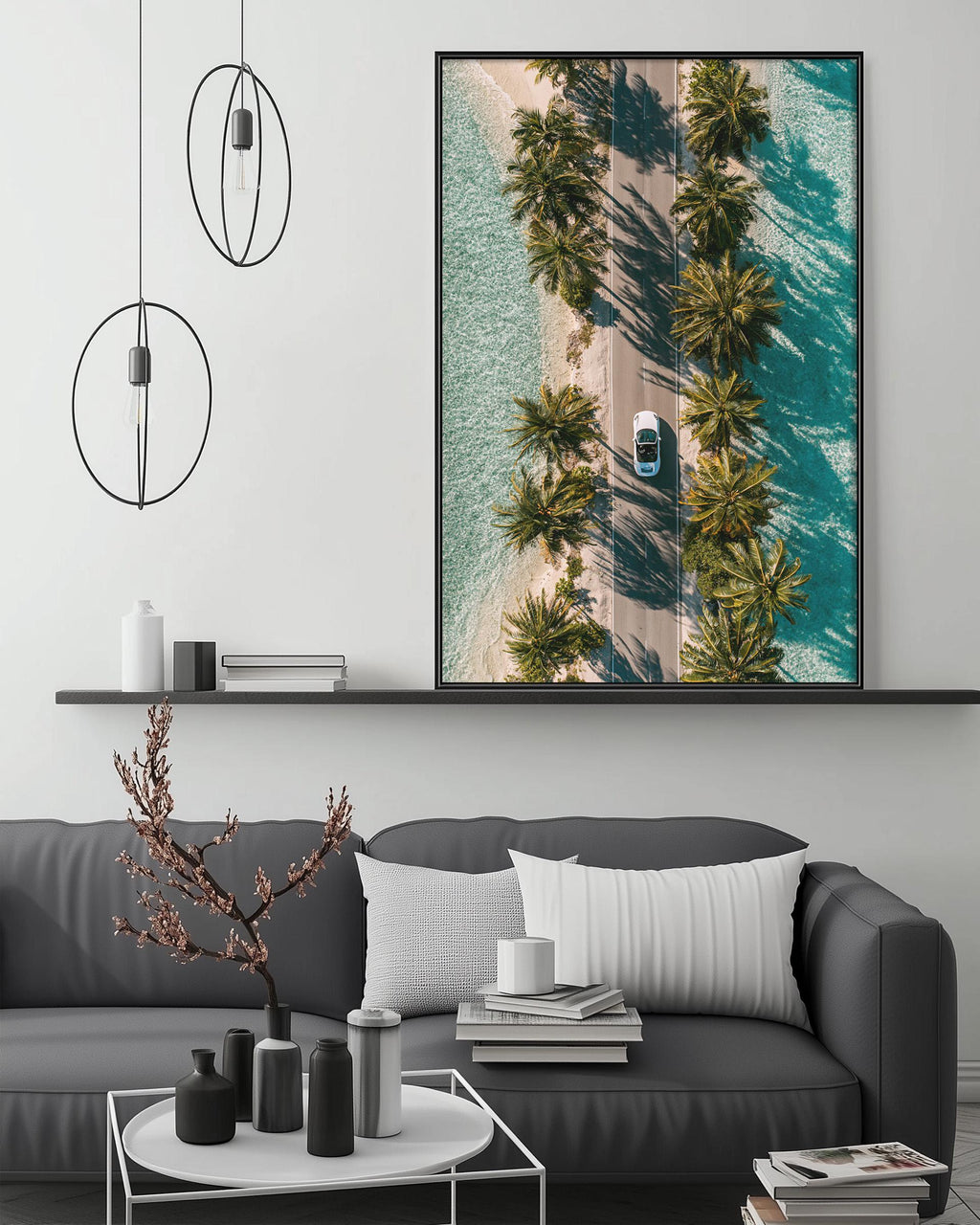 a modern living room with a gray sofa, a coffee table, and a large framed picture of a tropical beach with palm trees. The picture is hung on the wall above the sofa, creating a focal point in the room.