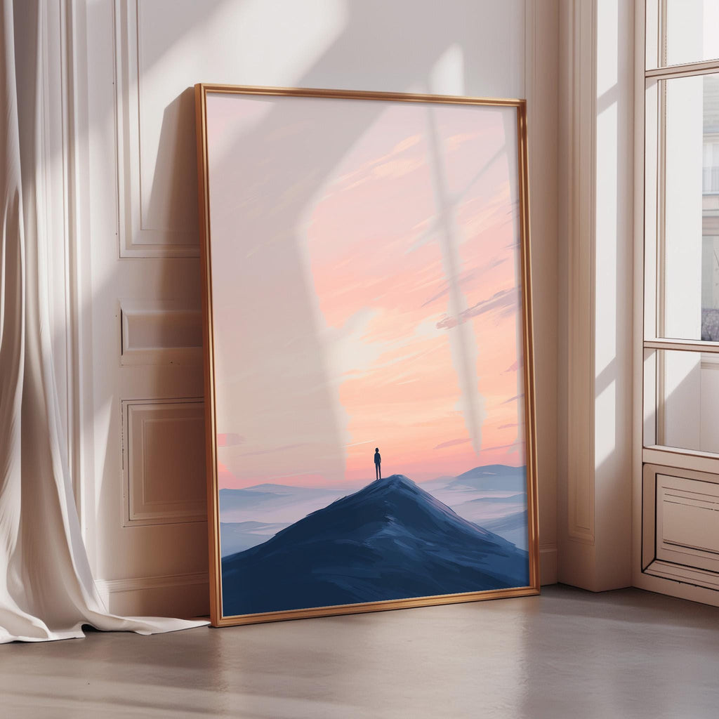 a large framed picture of a person standing on a mountain peak at sunset, with a serene and peaceful atmosphere.
