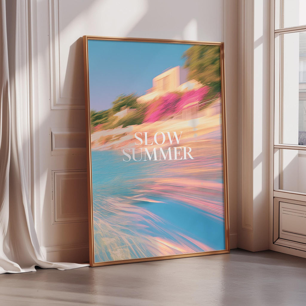 A framed poster with a vibrant, colorful beach scene and the text "SLOW SUMMER" displayed prominently.
