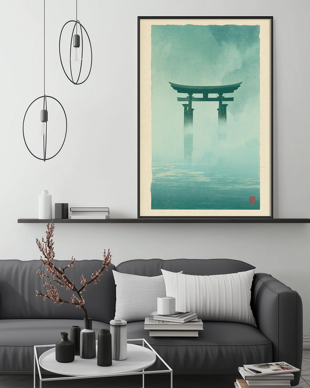 a living room with a gray sofa, a coffee table, and a framed poster of a torii gate hanging on the wall above the sofa.