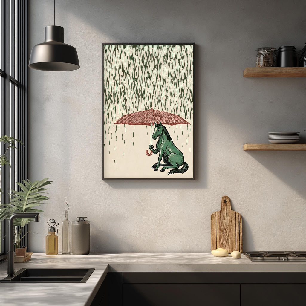 a kitchen counter with a framed illustration of a green horse holding an umbrella, sitting in the rain. The kitchen counter also has various items such as a cutting board, a bottle, and a plant.