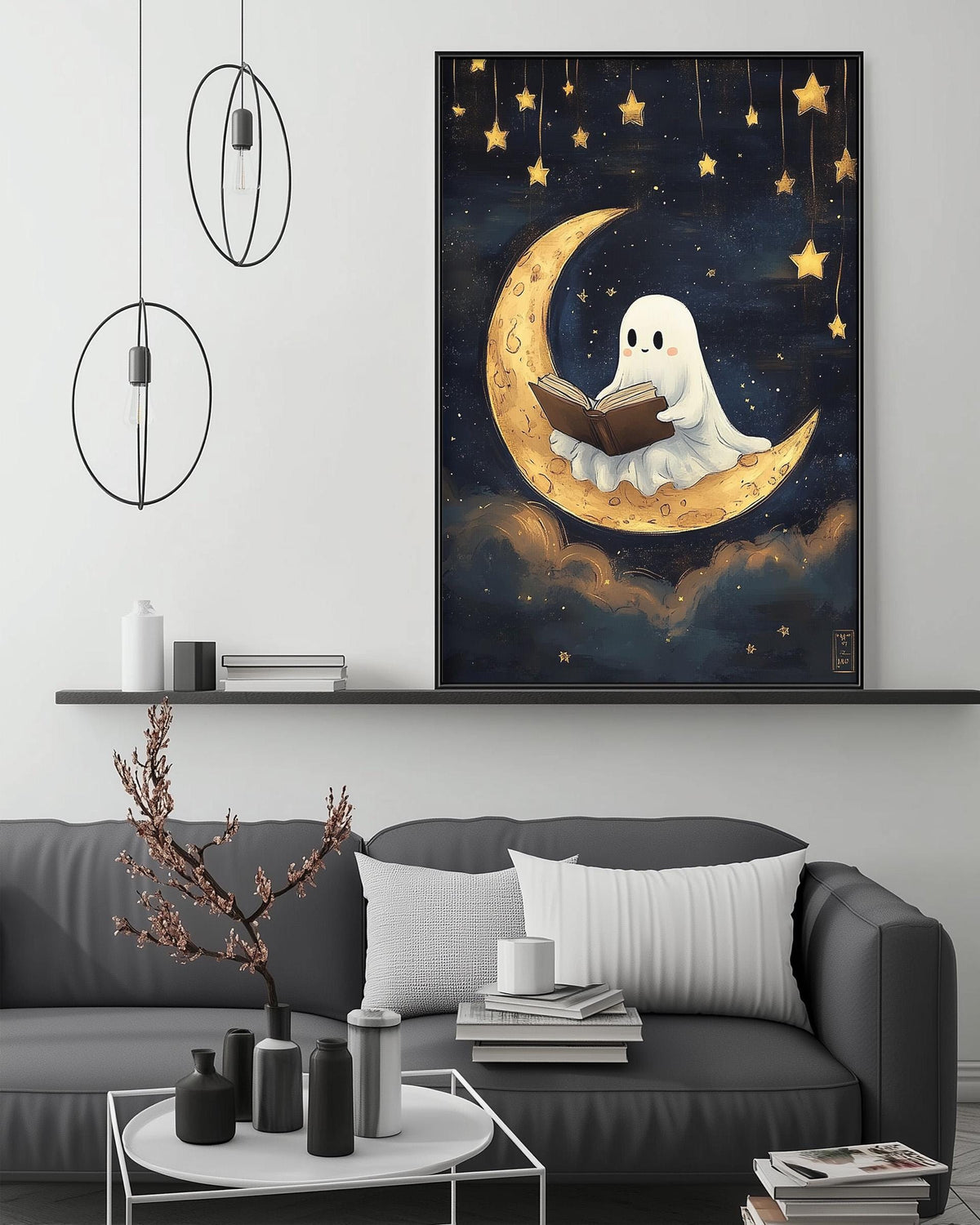 a cozy living room with a gray sofa, a coffee table, and a large framed artwork depicting a ghost reading a book on a crescent moon.