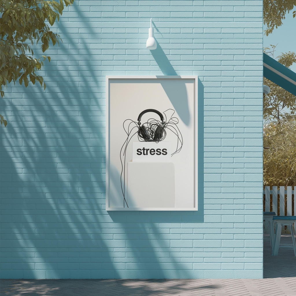 a framed poster with the word "stress" on it, mounted on a blue brick wall.
