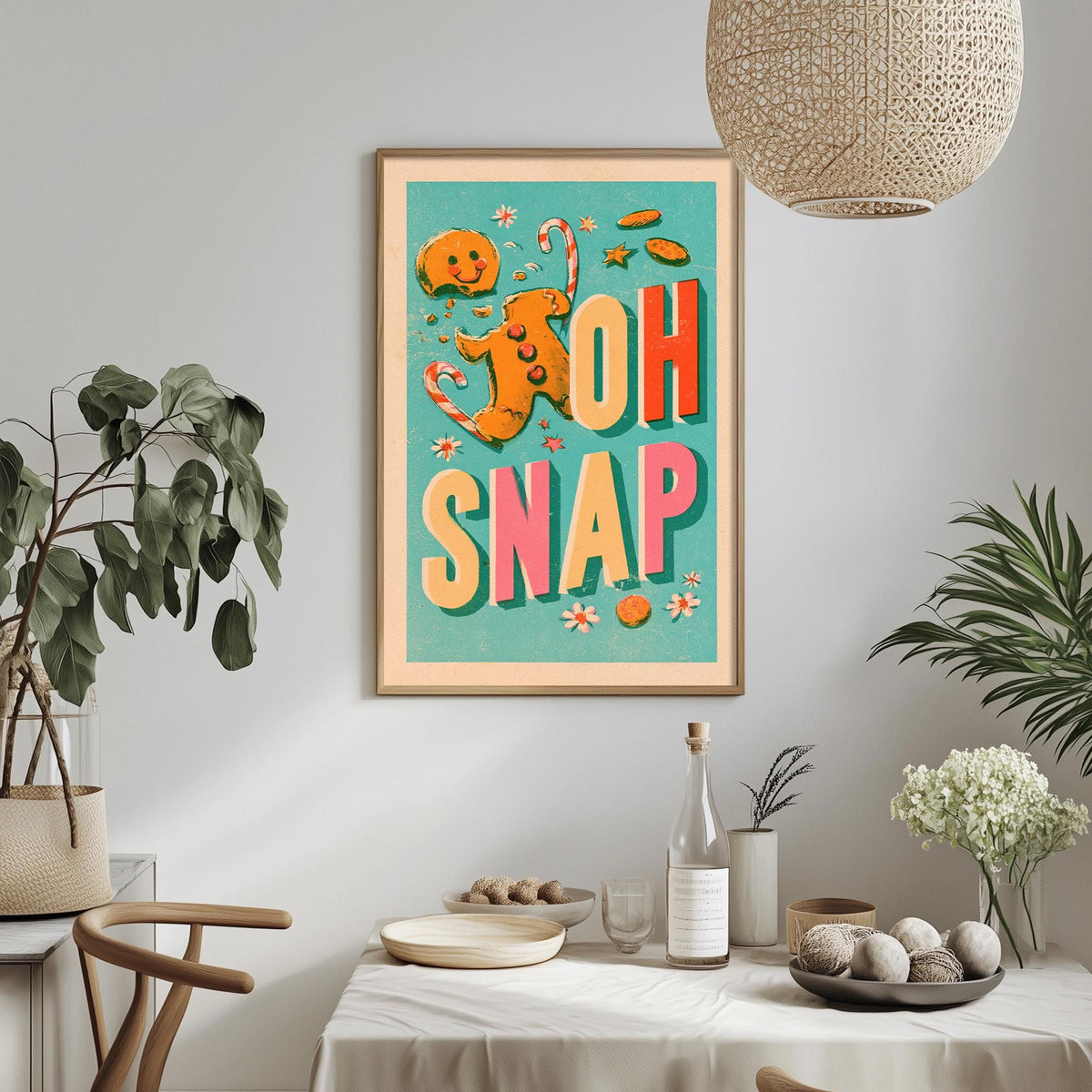 a framed poster with a colorful design hanging on a wall above a dining table with various items on it.