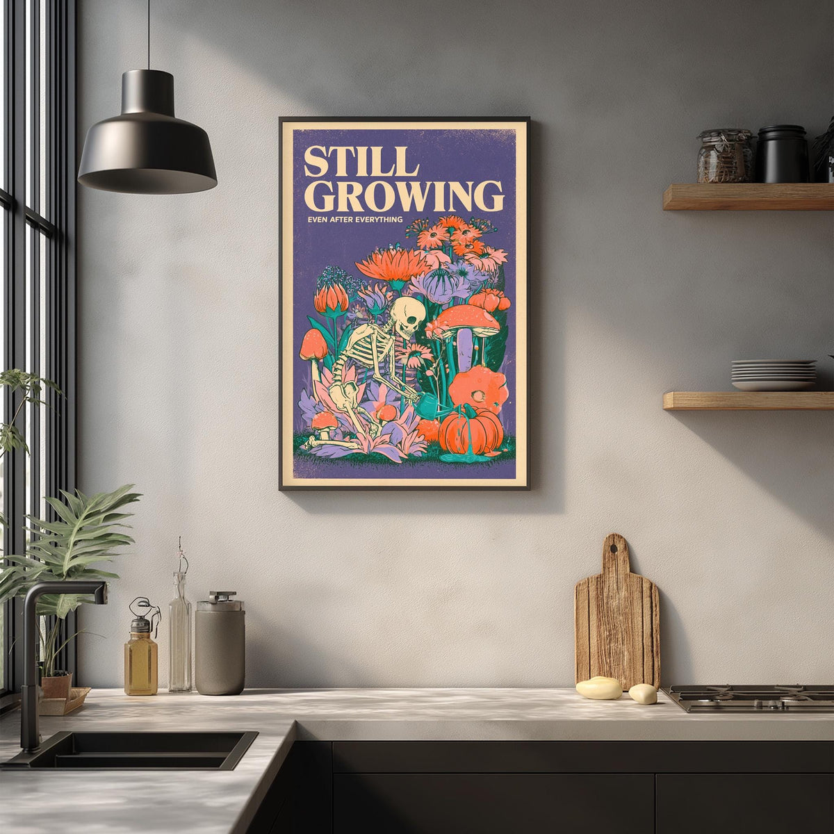 a framed poster with a skeleton and various flowers and plants hanging on a wall above a kitchen counter.
