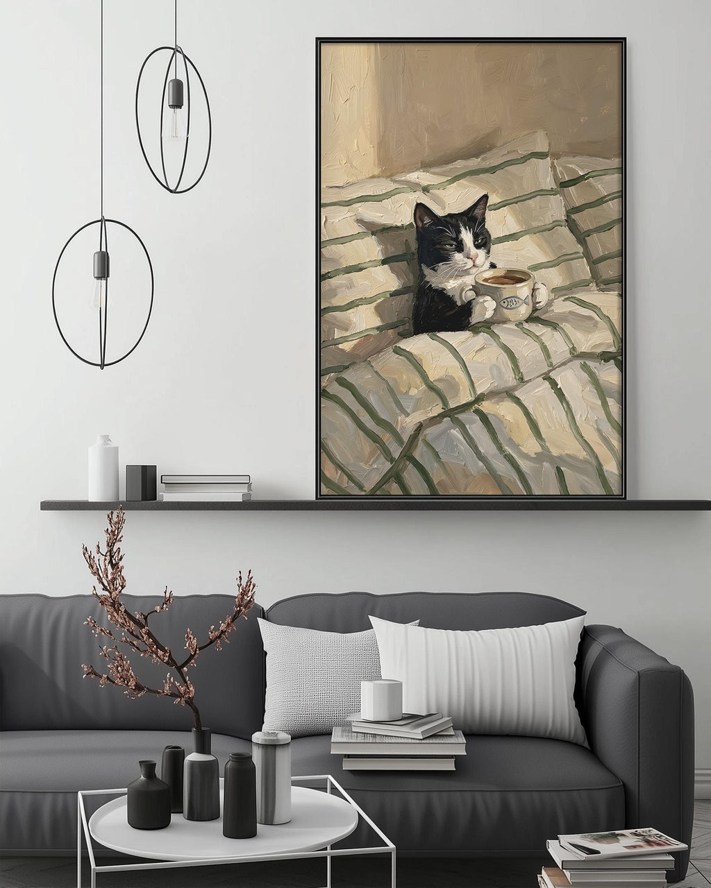 A black and white cat sitting on a striped blanket, holding a cup of tea, is the central focus of the image. The cat is positioned on a shelf above a gray couch, which is adorned with various decorative items such as vases and a potted plant. The overall scene is set in a cozy living room environment.