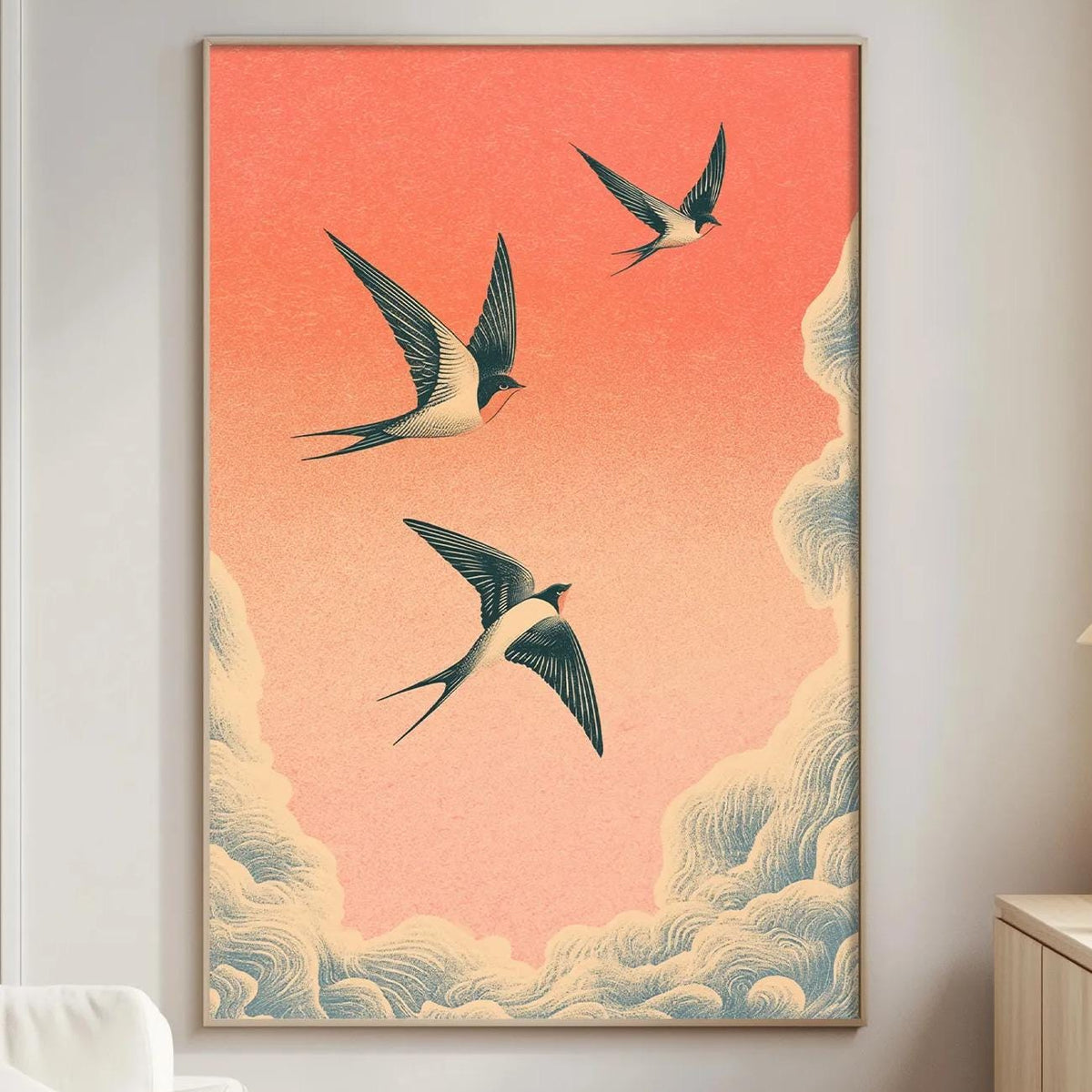 a living room with a large framed artwork depicting three birds flying in the sky, set against a gradient background of orange and blue.