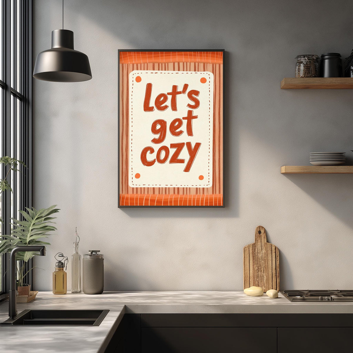 a kitchen counter with a framed poster that reads "Let's get cozy" above it. The kitchen counter also has various kitchen items such as a cutting board, a soap dish, and a bottle.