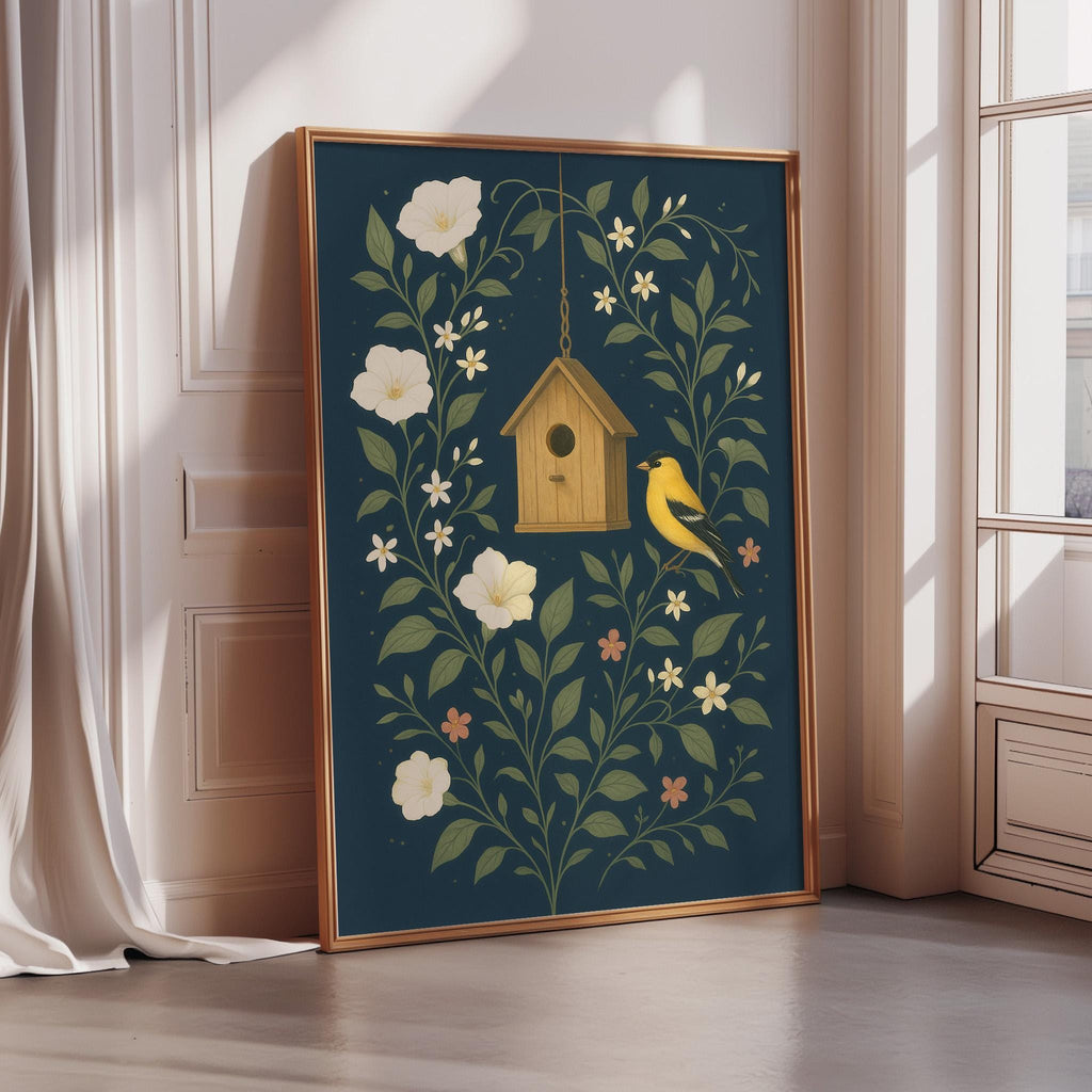A framed print depicting a birdhouse surrounded by flowers and leaves, with a yellow bird perched on the roof.