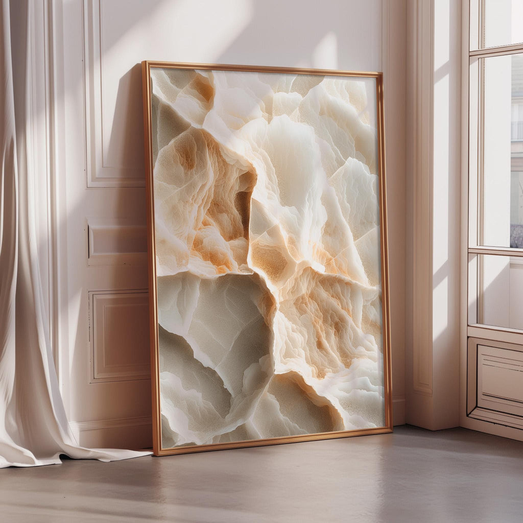 a large, framed picture of a marble-like stone texture, with a warm, earthy color palette of beige, orange, and white. The picture is displayed in a room with a window, creating a cozy and inviting atmosphere.