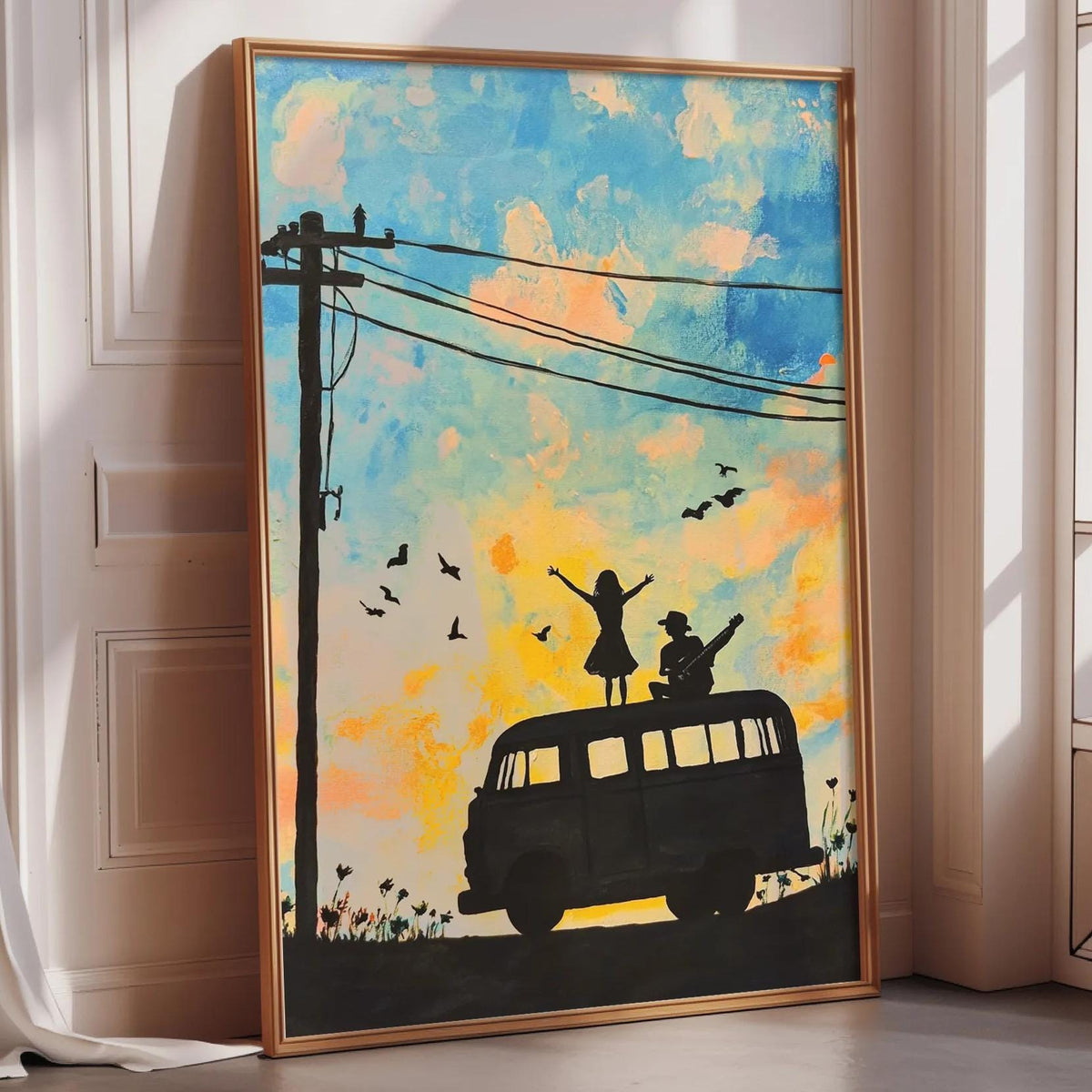 A framed painting depicting a silhouette of a person standing on a road with a van, surrounded by birds flying overhead against a colorful sky.