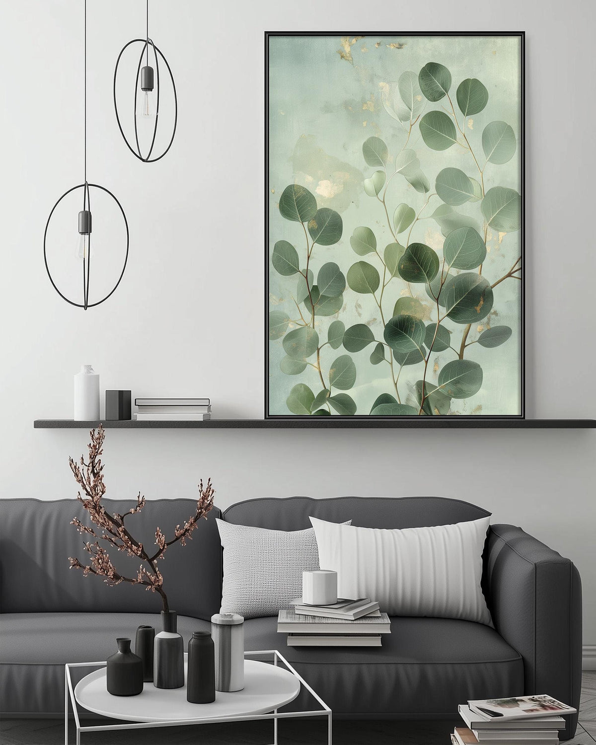 a modern living room with a gray sofa, a coffee table, and a large framed print of green leaves on the wall above the sofa.