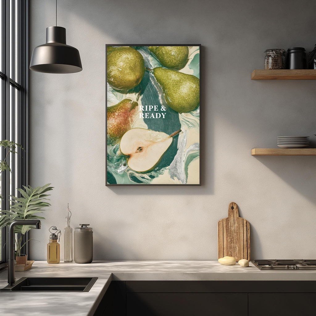 a kitchen counter with a framed poster of pears hanging on the wall above it. The poster has a vibrant green and white color scheme, and the text "Ripe & Ready" is prominently displayed.